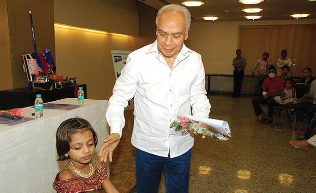 Mr. D.N. Budhrani with a young beneficiary