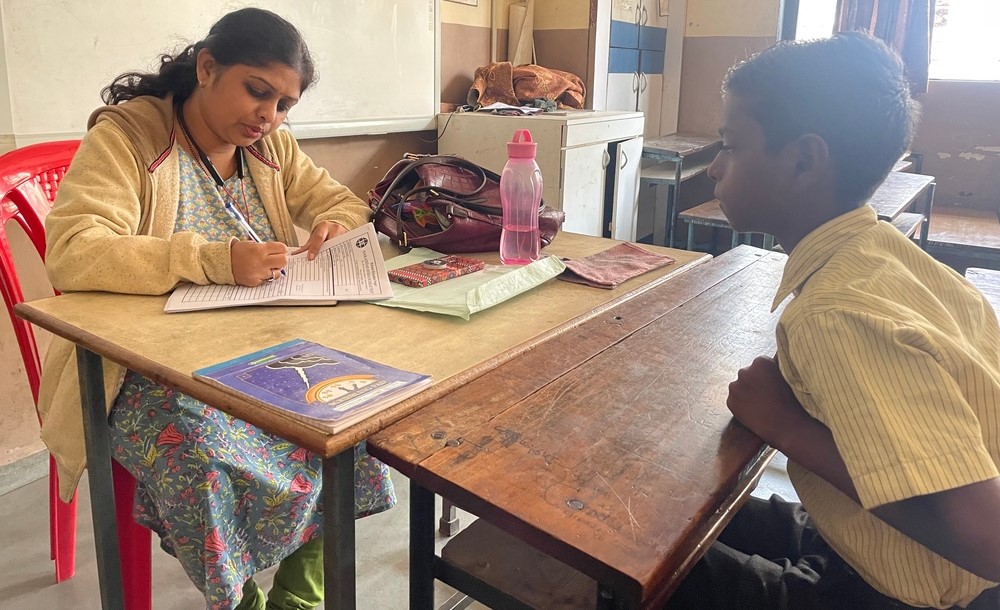 A student receiving fee support guidance from NMBT