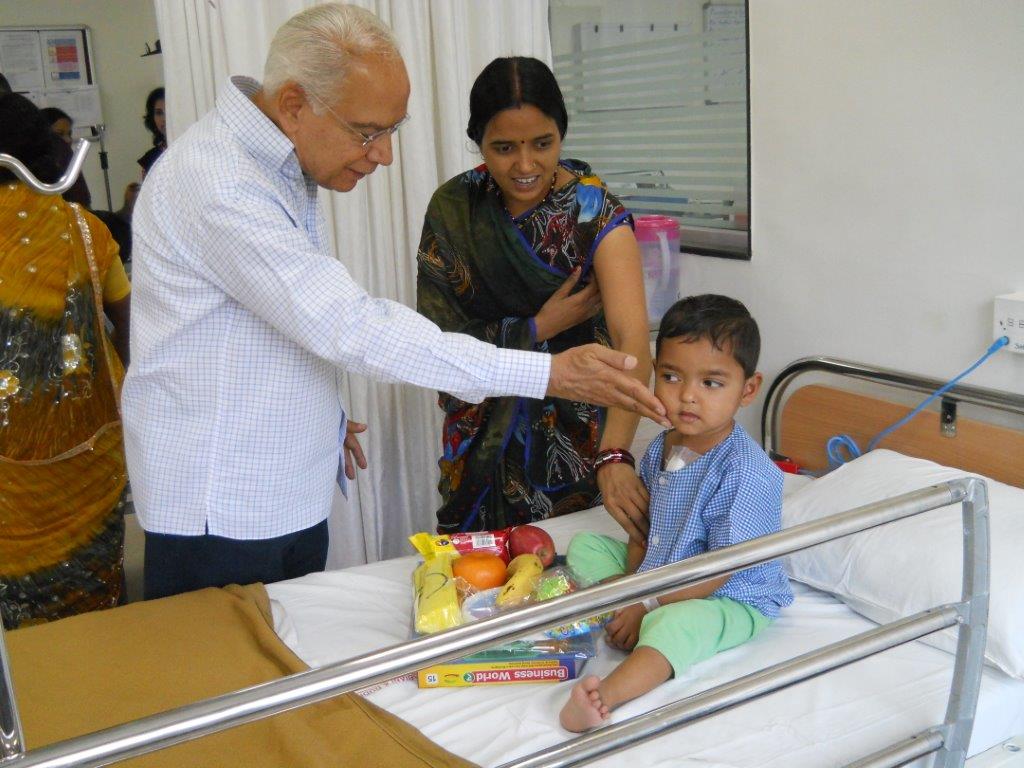 NMBT trustee consulting with a young heart patient and family